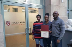 Chinyere with certificate of achievement at Harvard Medical School